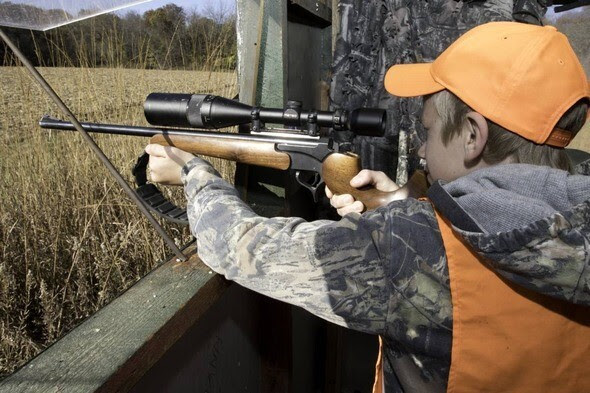 a kid aiming a gun